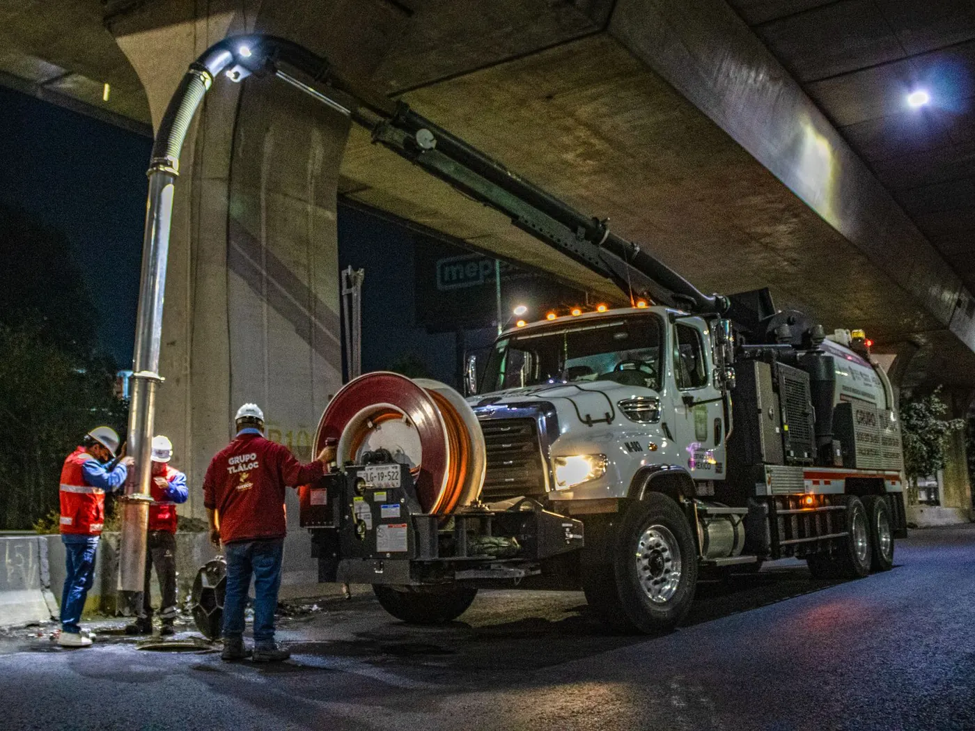 Illustrative photo of a vacuum truck operating at night