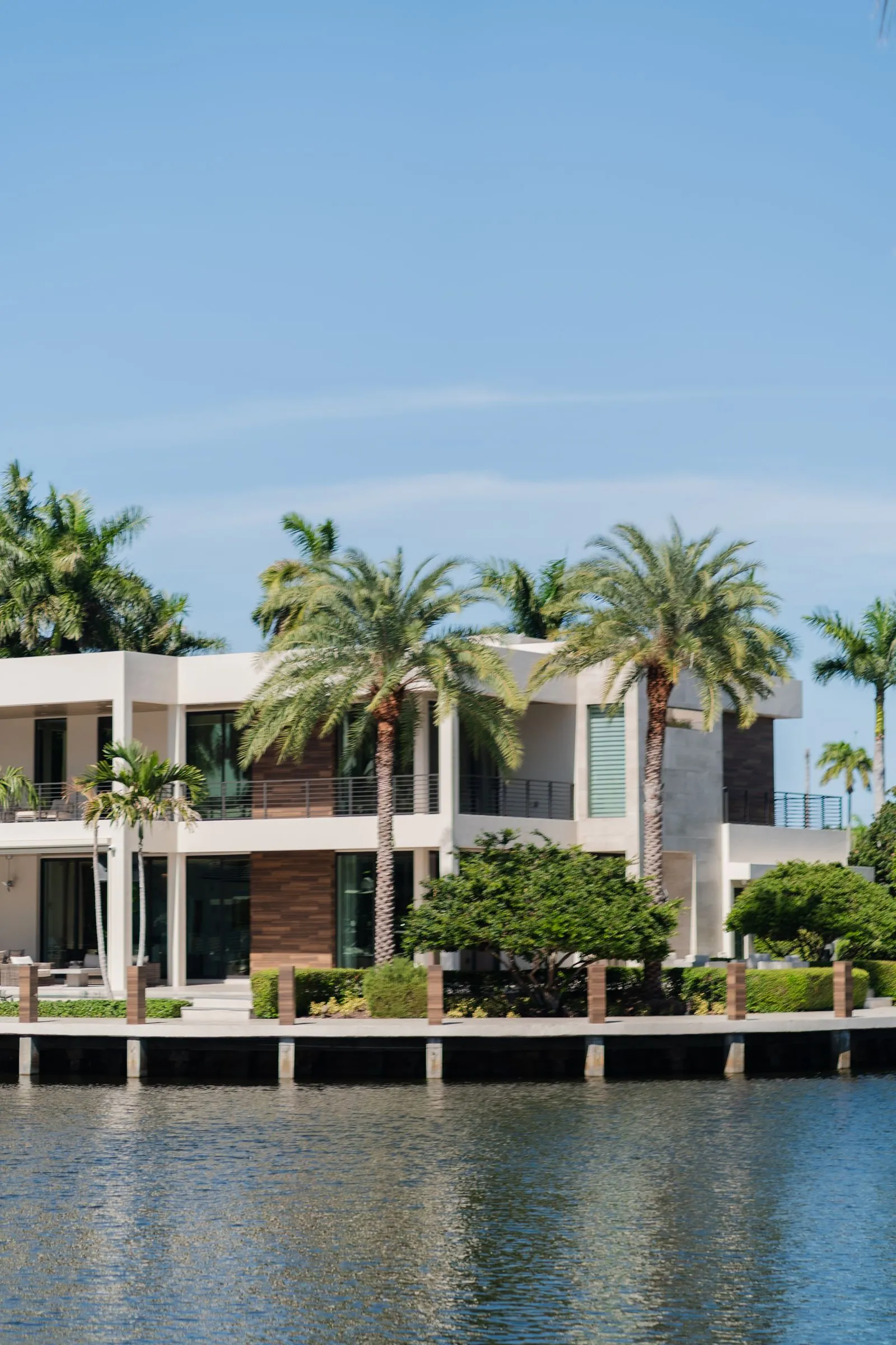 Waterfront home with palm trees along a Cape Coral canal